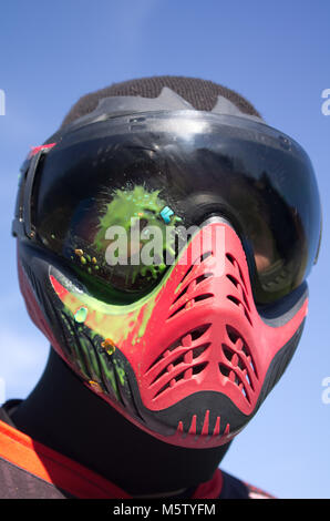 Paintball sport player with head shot by paint spot Stock Photo