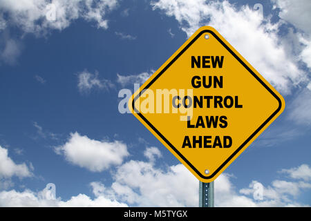 New Gun Control Laws Ahead road sigh against blue cloudy sky Stock Photo