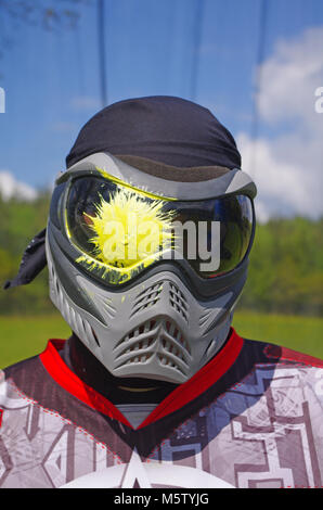 Paintball sport player with head shot by paint spot Stock Photo