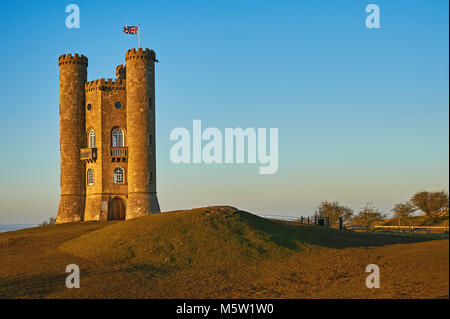 Broadway Tower, set on top of Fish Hill the second highest point in the Cotswolds, set against a clear blue late winter afternoon sky. Stock Photo