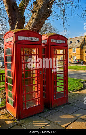 Two iconic red telephone kiosks on the High Street in the Cotswolds town of Broadway. Stock Photo