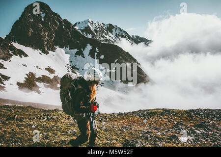 Woman climbing mountains Travel healthy lifestyle adventure concept active summer vacations outdoor sport girl with backpack and helmet Stock Photo