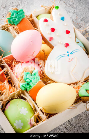 Easter holiday concept, sweet cookies in form of carrots, Easter bunny, with colorful eggs, close view Stock Photo