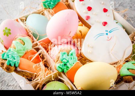Easter holiday concept, sweet cookies in form of carrots, Easter bunny, with colorful eggs, close view Stock Photo