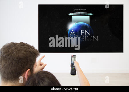 back view couple watching movie television at home Stock Photo