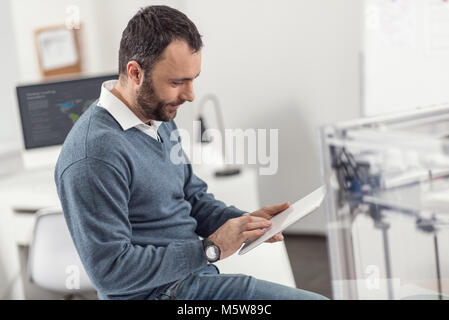 Handsome engineer working on tablet in office Stock Photo