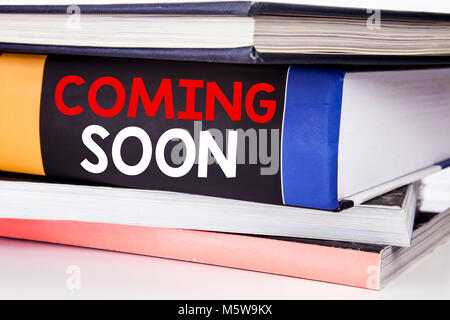 Hand writing text caption inspiration showing Coming Soon. Business concept for Under Construction written on the book the white background. Stock Photo