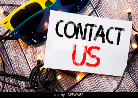 Writing text showing Contact Us. Business concept for Customer Support written on old wood wooden background with sunglasses Stock Photo
