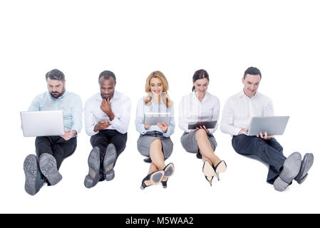 Alert colleagues working on their gadgets Stock Photo