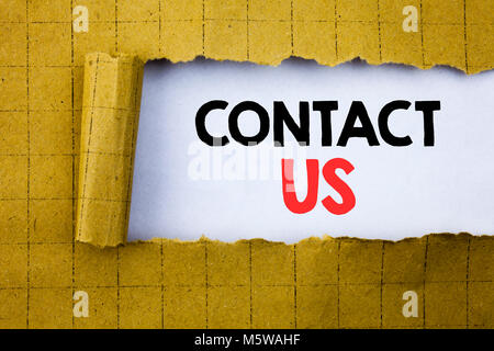 Contact Us. Business concept for Customer Support written on white paper on yellow folded paper. Stock Photo
