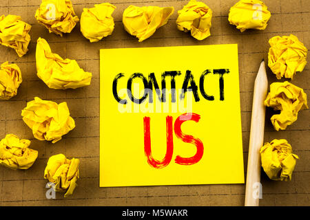 Contact Us. Business concept for Customer Support written on sticky note paper on vintage background. Folded yellow papers on the background Stock Photo