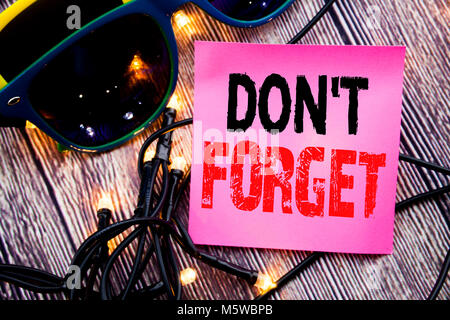 Hand writing text caption showing Do Not Forget. Business concept for Don t memory Remider written on the wood with sunglasses copy space Stock Photo