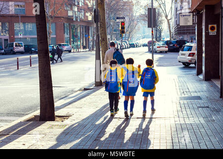 BARCELONA, SPAIN - 12 JANUARY 2018: Boys athletes go from training to football on the street of Barcelona Stock Photo