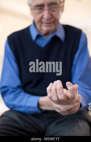 Senior Man At Home Suffering With Arthritis Stock Photo
