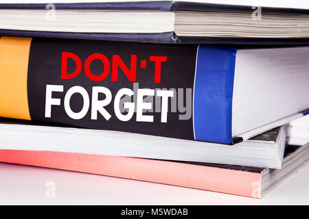 Hand writing text caption inspiration showing Do Not Forget. Business concept for Don t memory Remider written on the book the white background. Stock Photo