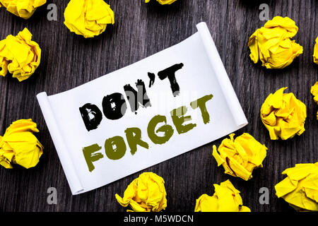 Writing text showing Do Not Forget. Business concept for Don t memory Remider Written on sticky note notepad notebook book wooden background with yell Stock Photo