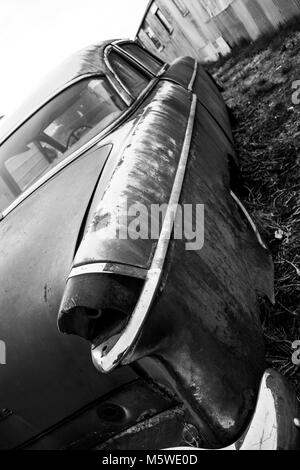 Antique vintage american automobile with a broken tail light in black and white Stock Photo
