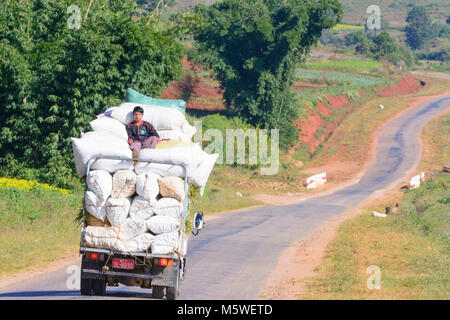 Kalaw: rural road, truck, bags with oranges, , Shan State, Myanmar (Burma) Stock Photo