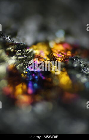 This is iridescent colorful copper ore called peacock ore or chalcopyrite from Virtasalmi copper mine in Finland.  Microscope image. Stock Photo