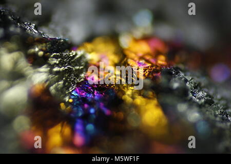 This is iridescent colorful copper ore called peacock ore or chalcopyrite from Virtasalmi copper mine in Finland.  Microscope image. Stock Photo