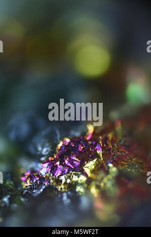 This is iridescent colorful copper ore called peacock ore or chalcopyrite from Virtasalmi copper mine in Finland.  Microscope image. Stock Photo