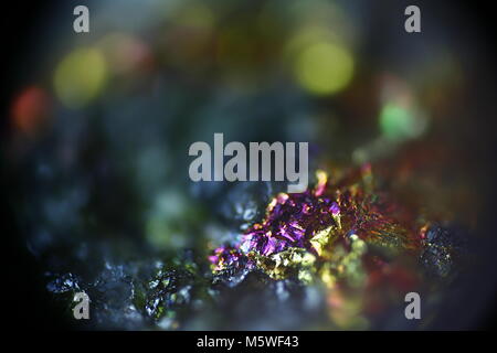 This is iridescent colorful copper ore called peacock ore or chalcopyrite from Virtasalmi copper mine in Finland.  Microscope image. Stock Photo