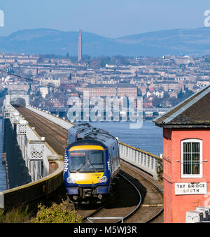View of Scotrail diesel passenger train travelling towards Dundee across the Tay Rail Bridge at Wormit in Tayside, Scotland, United Kingdom Stock Photo