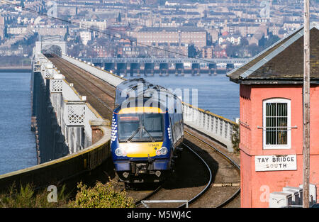 View of Scotrail diesel passenger train travelling to Dundee across the Tay Rail Bridge at Wormit in Tayside, Scotland, United Kingdom Stock Photo