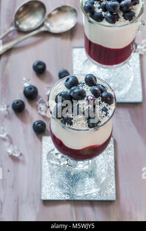 Blueberry coconut yogurt dessert garnished with fresh fruit Stock Photo