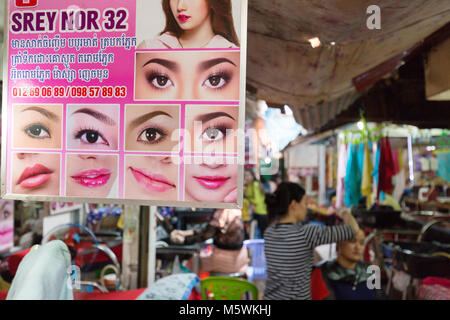 Street beauty therapists doing  facials for  customers, example of Cambodia lifestyle;  Phnom Penh, Cambodia, Asia Stock Photo