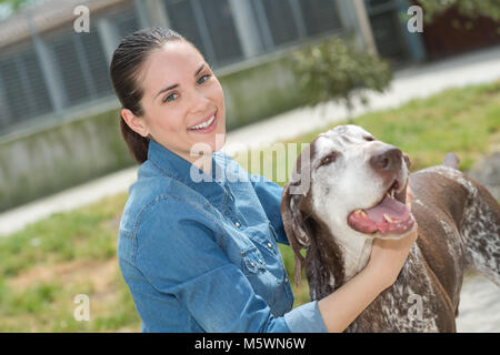 shelter keeper loves her residents Stock Photo