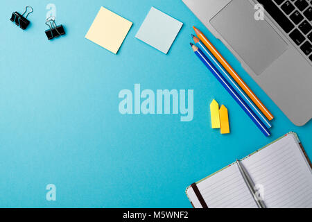 Start of Morning work office desk with computer laptop pencil Sheet paper notebook pen blue texture table Business concept background Stock Photo