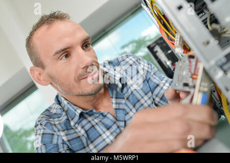 computer engineer working on broken console Stock Photo