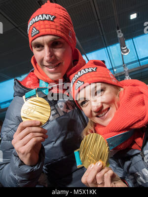 26 February 2018, Germany, Frankfurt am Main: The figure skating couple Aljona Savchenko (R) and Bruno Massot is being welcomed by fans and shows their gold medals after the landing of the Lufthansa aircraft LH713 with more than 150 other athletes, coaches and officials on board. Photo: Boris Roessler/dpa Stock Photo