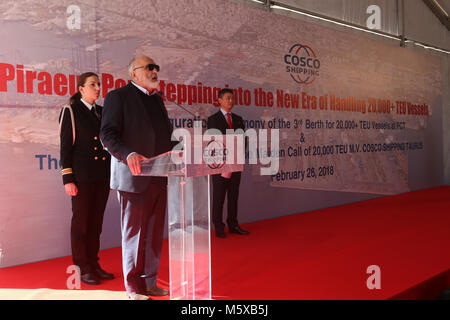 (180227) -- PIRAEUS PORT, Feb. 27, 2018 (Xinhua) -- Greek Shipping Minister Panayiotis Kouroumblis (front) speaks during a ceremony for the welcome of the maiden call of China's COSCO Shipping Taurus and the inauguration of the 3rd berth for 20,000 plus twenty-foot equivalent unit (TEU) vessels at Piraeus Container Terminal (PCT) of Piraeus port, Greece, Feb. 26, 2018. Piraeus port, the largest harbor in Greece, entered a new era of handling 20,000 plus TEU vessels on Monday when China's COSCO Shipping Taurus giga container vessel, one of the biggest worldwide, docked here. The 400 m Taurus is Stock Photo