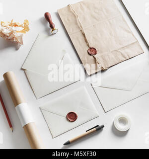 Vintage still life with postal accessories. Blank stationery and envelopes on paper background. Responsive design mockup. Stock Photo