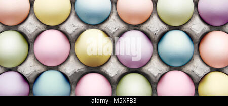 Dyed Easter eggs in carton Stock Photo