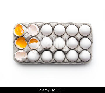 Cracked eggs in a carton Stock Photo