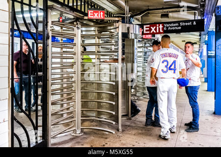 New York City, USA - October 28, 2017: Subway station entrance with people in underground transit in NYC, Spring Vandam Street sign exit at turnstile, Stock Photo