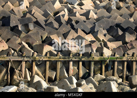 Concrete riprap and timber coastal defences, Seaford, UK Stock Photo