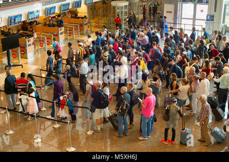 SINGAPORE - JAN 13, 2017: People waiting in queue at arrival immigration of Changi airport. Changi International Airport serves more than 100 airlines Stock Photo