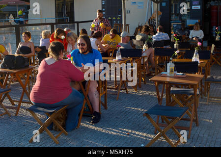 PORTO, PORTUGAL - NOVEMBER 16, 2017: People at a street restaurant at Old Town of Porto. Porto is a second largest city and popular tourist destinatio Stock Photo