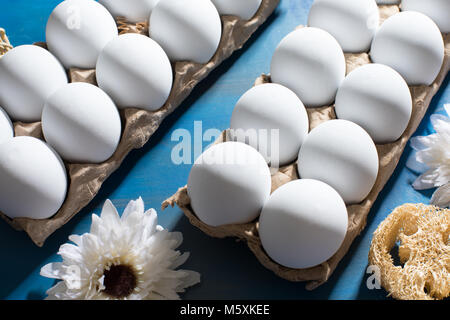 Clean white eggs on a deep blue background, flat lay Stock Photo
