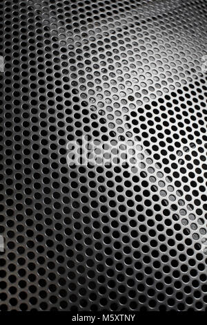 Photo of a loudspeaker grill as a background.  Selective focus through the middle. Stock Photo