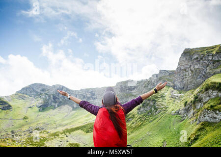 Image of woman with backpack against background of mountain landscape Stock Photo