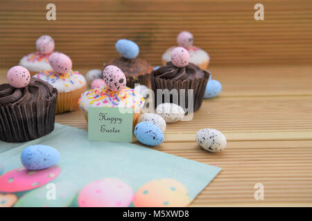 bright colorful Easter cakes on rustic wood table Stock Photo