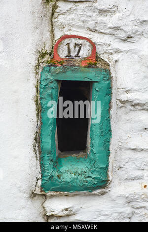 Handmade number 17 sign with letterbox set in a concrete wall Stock Photo