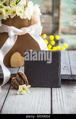 Easter eggs on wood. Colorful Easter holiday concept with  eggs in wisker basket in nature Stock Photo