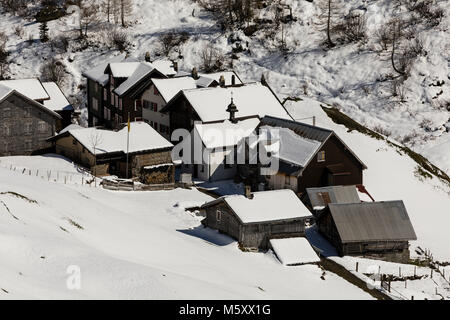 Old traditional village in winter in the Meiental valley in central Switzerland Stock Photo