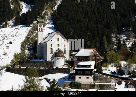Old traditional village with church in winter in the Meiental valley in central Switzerland Stock Photo